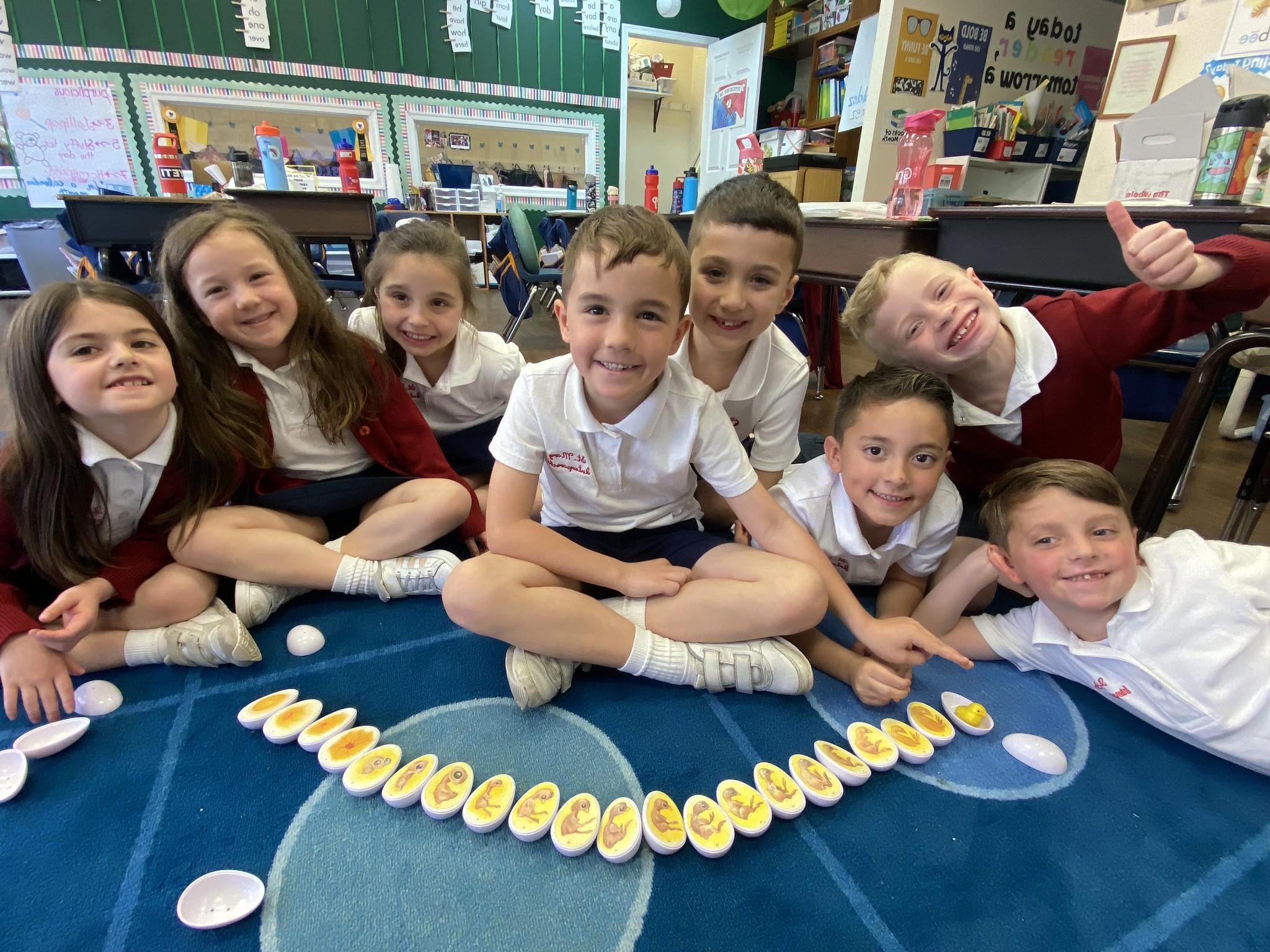 A group of smiling students in their classroom